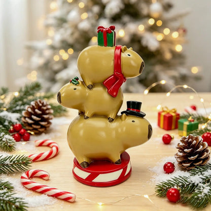 the capybara triple stack tower displayed with candy canes, pine cones, and fairy lights in front of a snowy Christmas tree