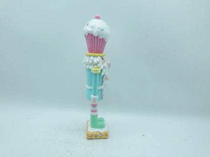 Side view of the nutcracker figurine with pink-and-white striped leggings and cookie base