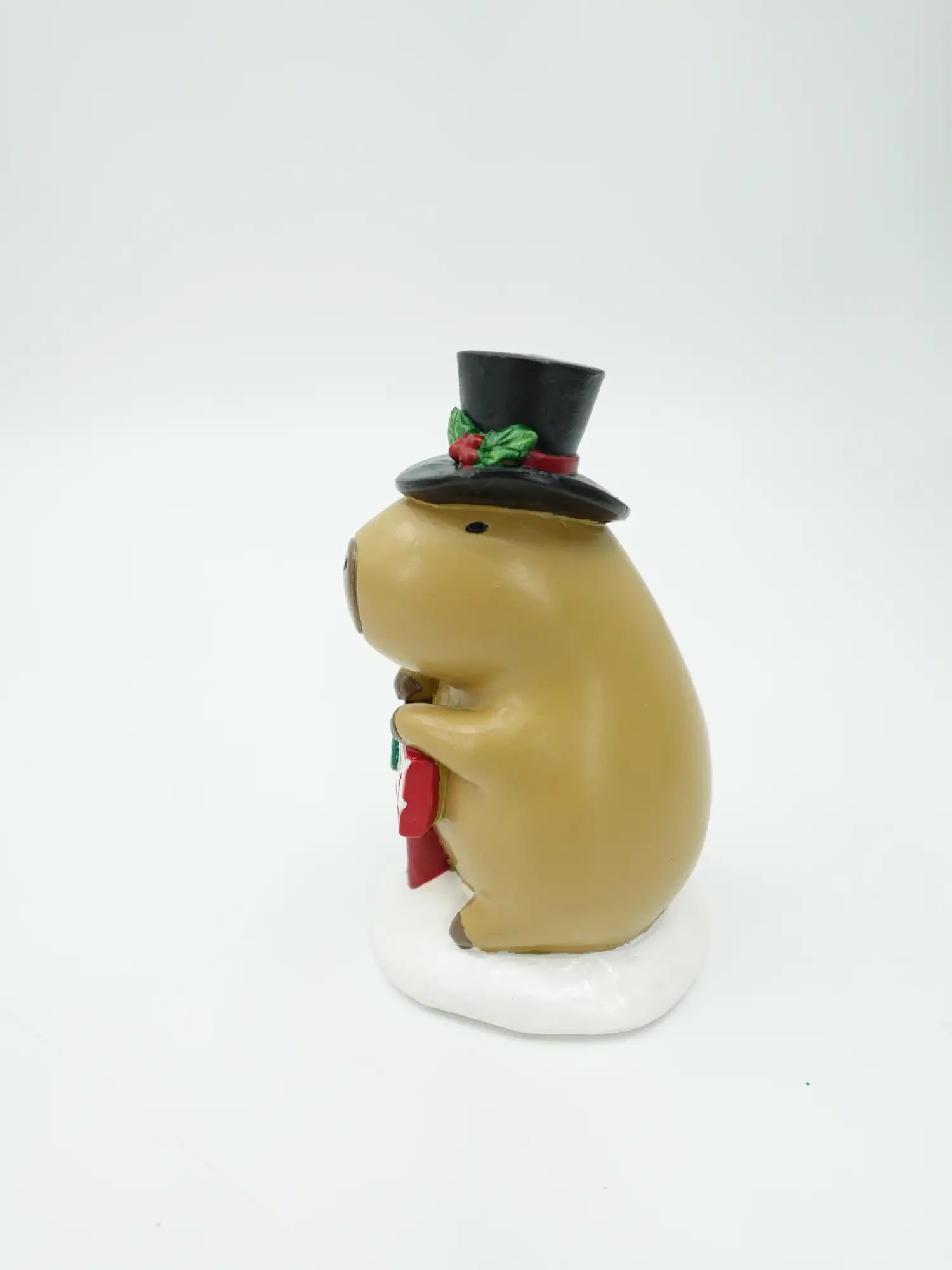 the capybara JOY sign figurine showing the top hat profile and the signpost detail