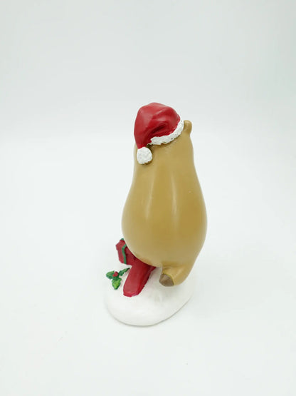 the capybara scooter figurine showing the Santa hat pom-pom, red deck, and gift box from behind, back view