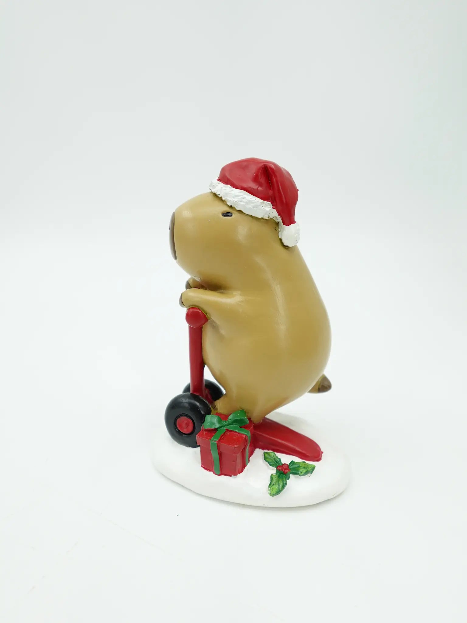 the capybara riding the red scooter figurine showing the handlebar grip and wheel detail