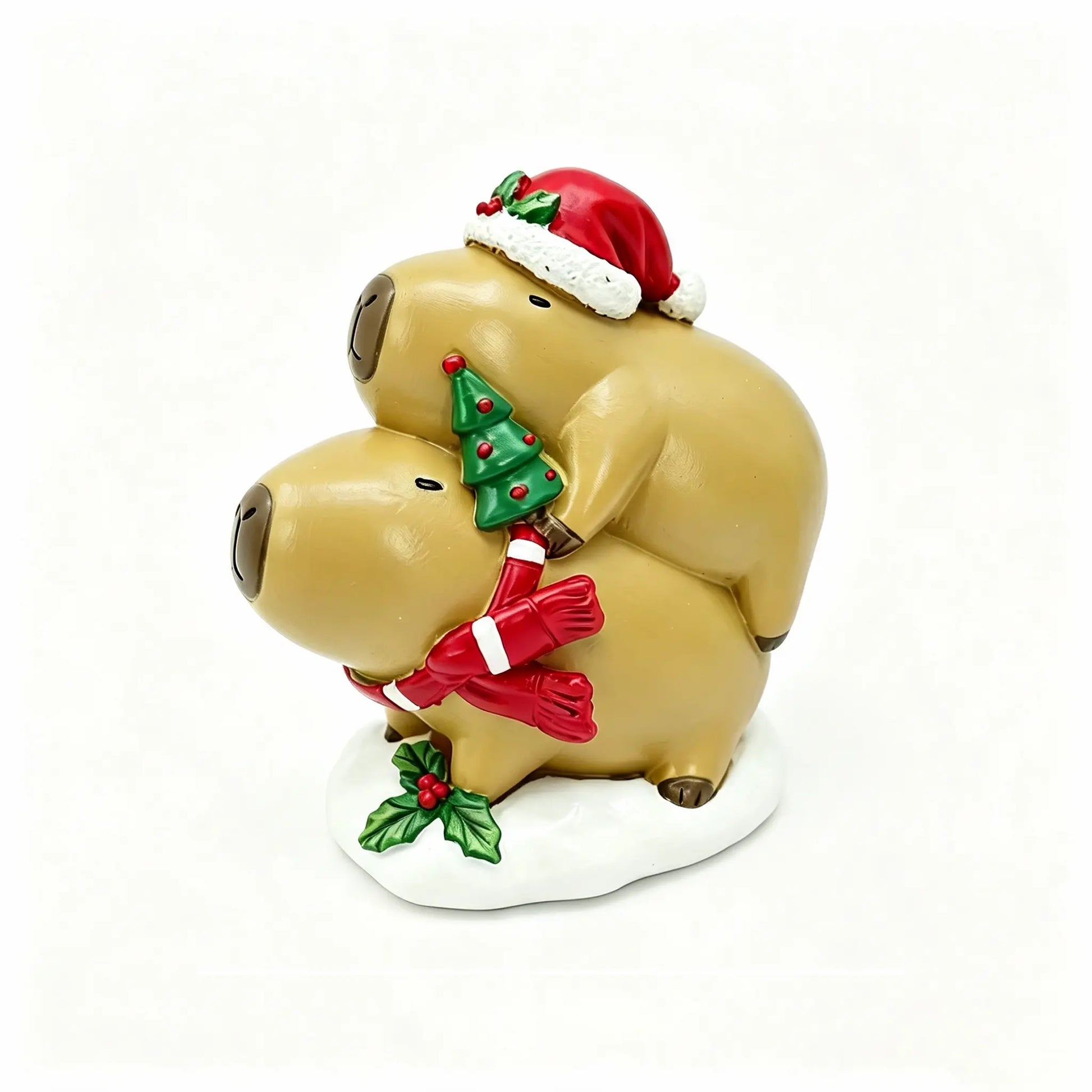 Hand-painted Christmas capybara stacking duo on white background, one in Santa hat with holly holding a mini tree, the other with a red candy-cane striped scarf on a snowy base