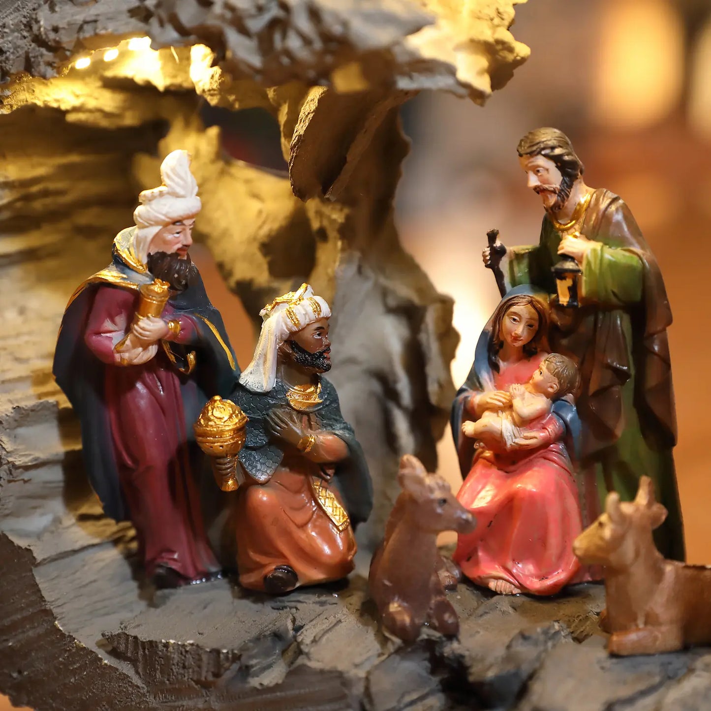 Close-up illuminated Christmas manger scene featuring Wise Men and Holy Family