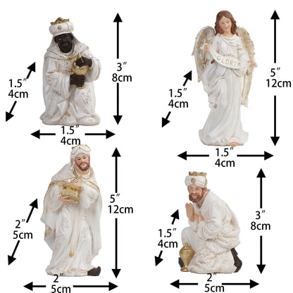 Nativity wise men and angel figurines with "GLORIA" banner, white and gold religious Christmas decorations.