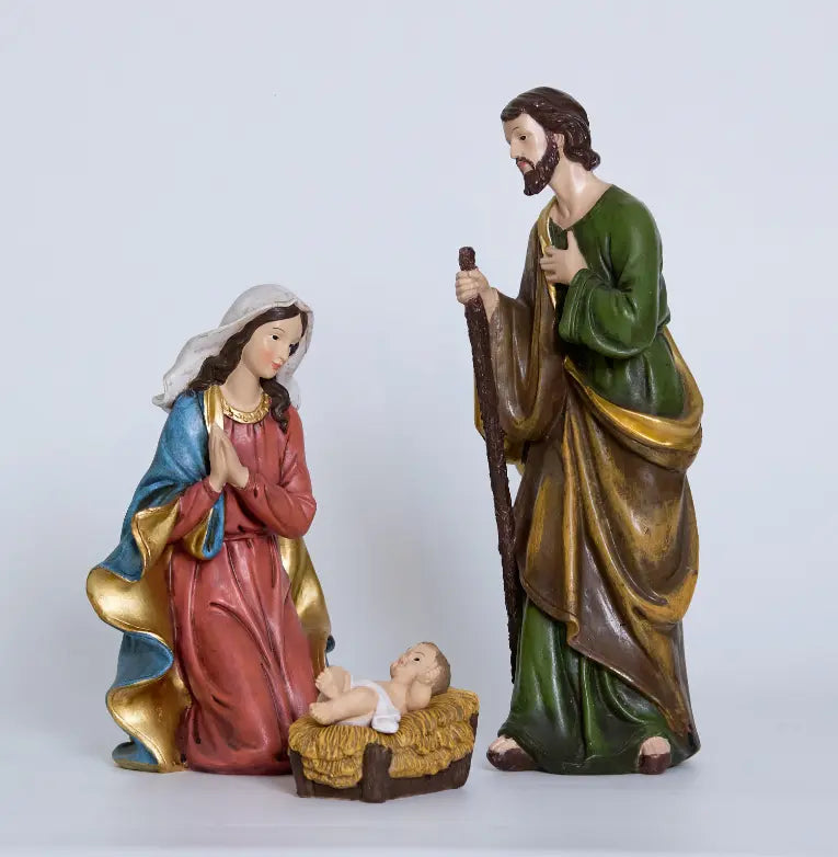 A three-piece nativity figurine set featuring Mary, Joseph, and baby Jesus in a straw manger, shown against a plain background.