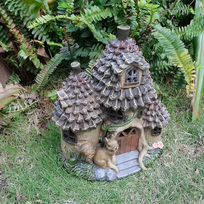 Whimsical squirrel cottage in garden setting side angle view
