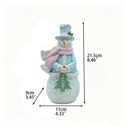 Male snowman figurine with blue top hat, pink scarf, and JOY Christmas tree detail, 21.5cm tall, front view with dimensions